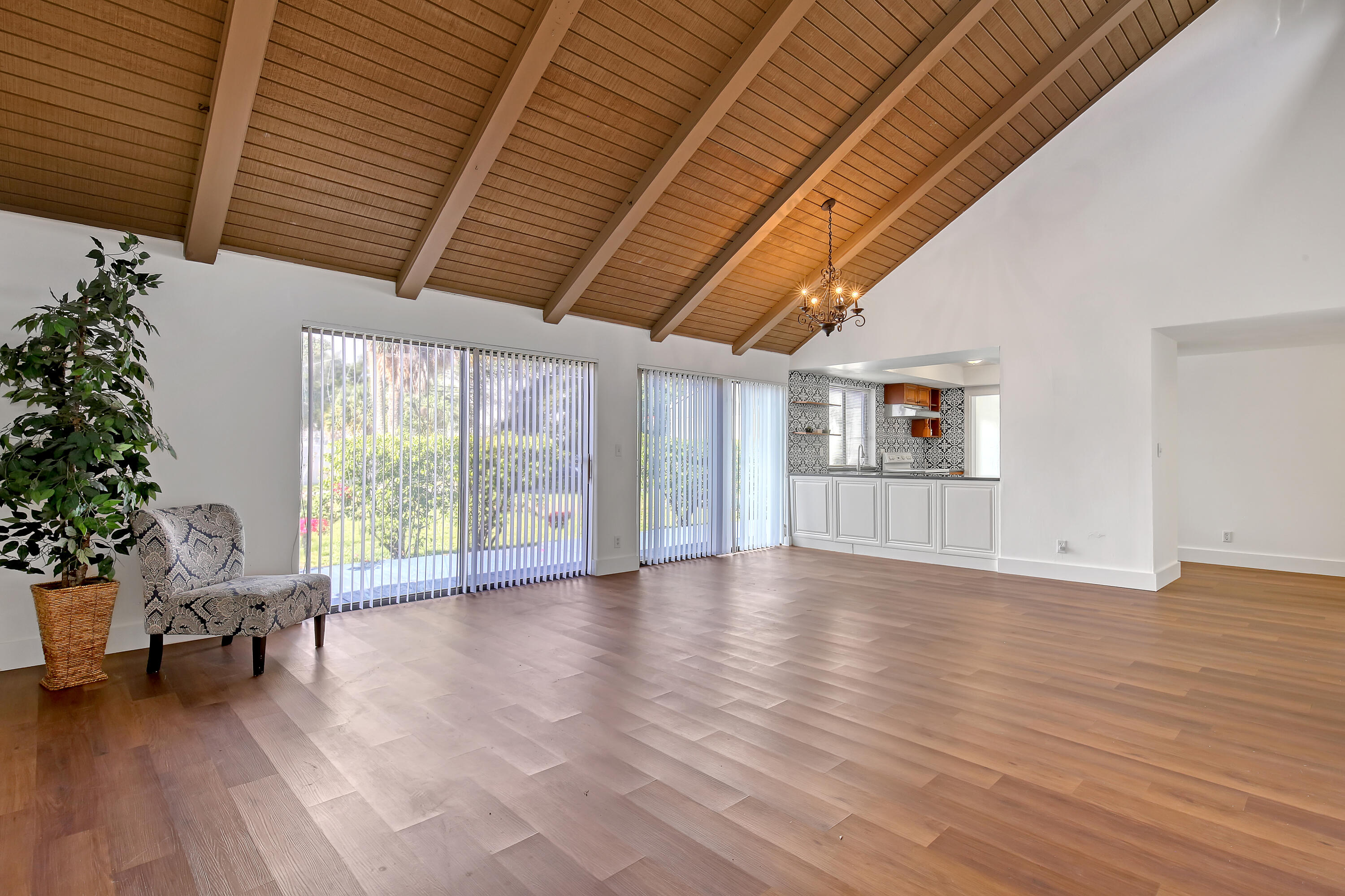241 Northwest 15th Street Boca Raton, FL 33432 - Photo 6 of 34 a view of an empty room with a window and wooden floor