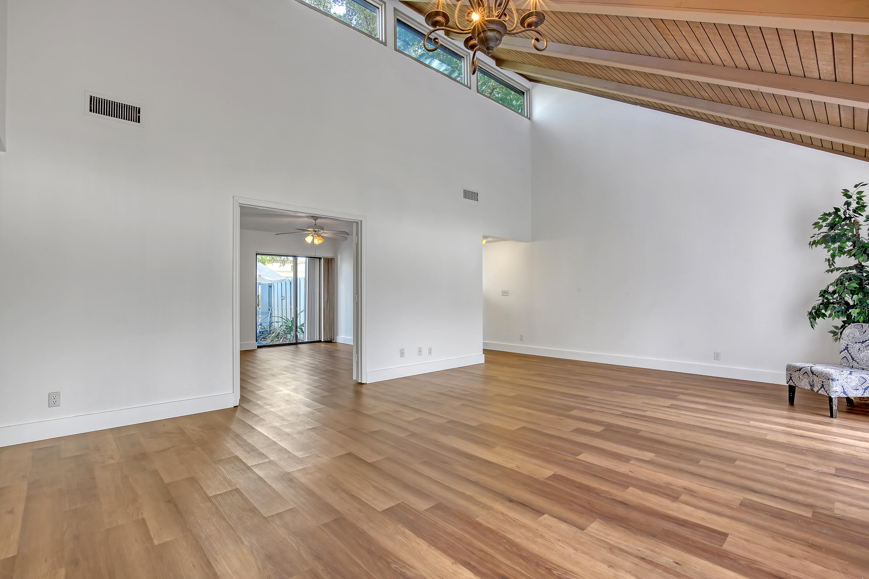 241 Northwest 15th Street Boca Raton, FL 33432 - Photo 7 of 34 a view of an empty room with wooden floor and a window