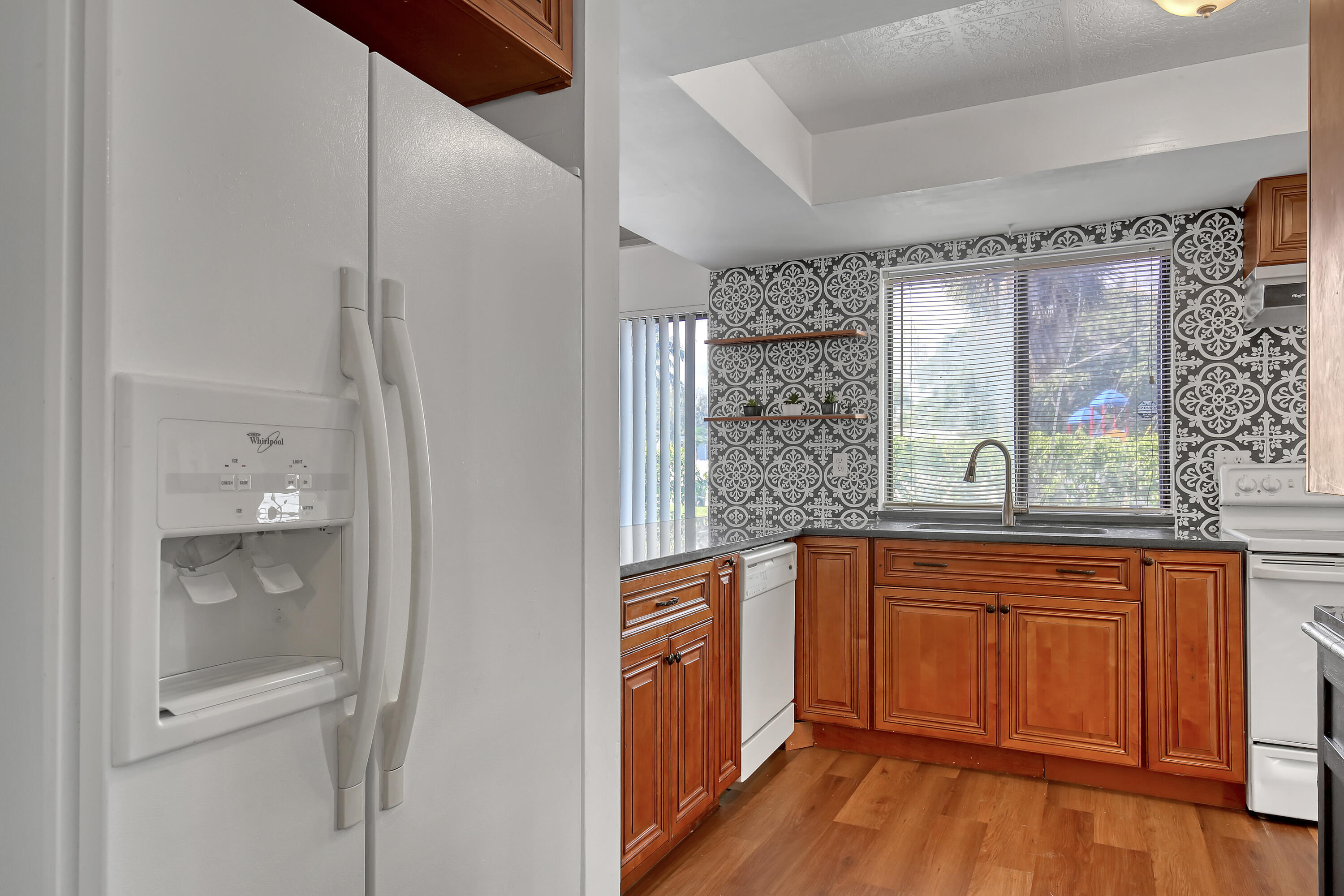 241 Northwest 15th Street Boca Raton, FL 33432 - Photo 10 of 34 a kitchen with stainless steel appliances granite countertop a refrigerator and a sink