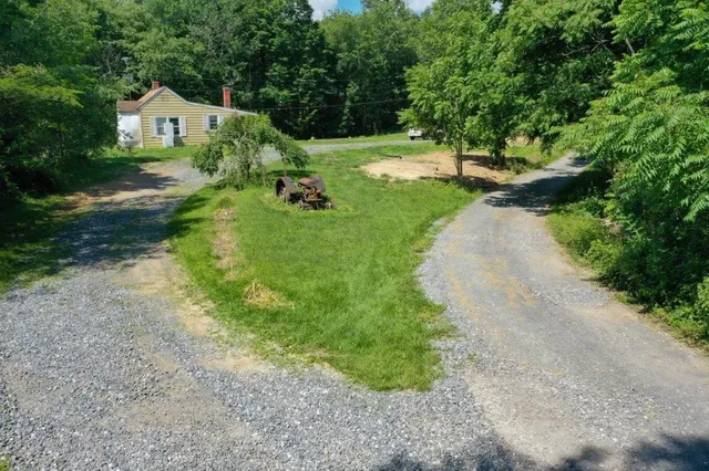 a view of backyard of house with green space