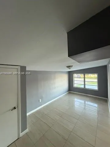 a view of an empty room and window