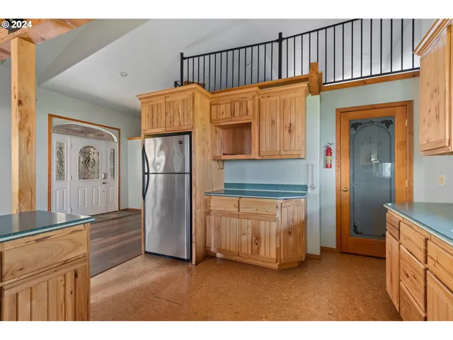 a kitchen with stainless steel appliances granite countertop a refrigerator a stove and a sink