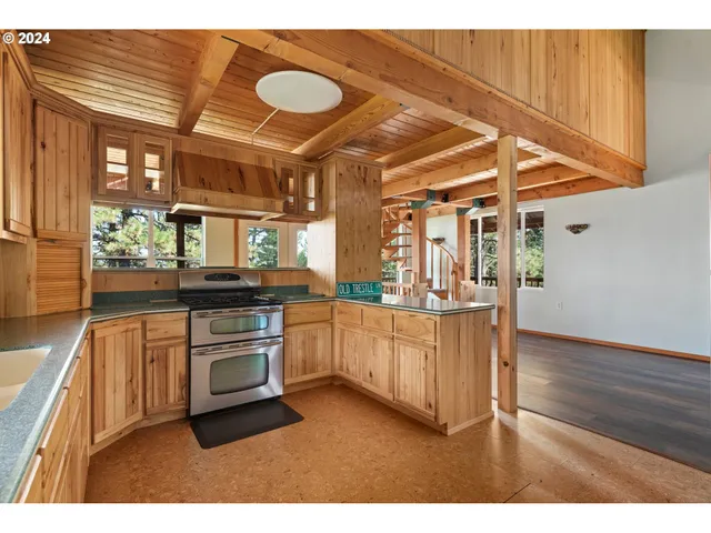 a kitchen with granite countertop a stove a sink and a microwave