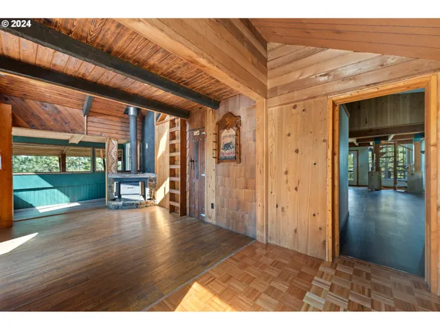 a view of a utility room with door and wooden floor