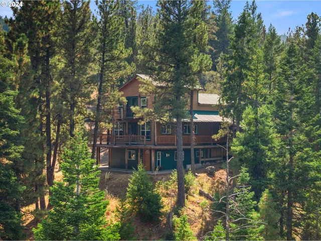 a backyard of a house with a yard and outdoor seating