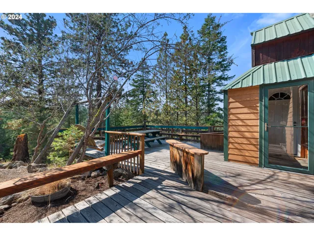 a balcony with wooden floor and outdoor seating
