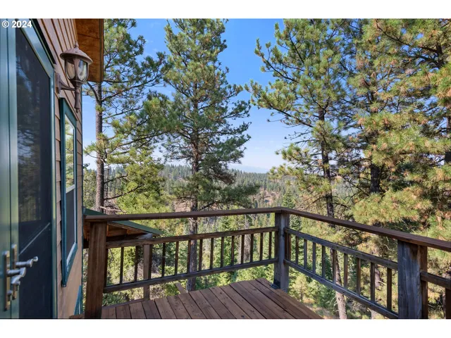 a view of a balcony with wooden floor and fence
