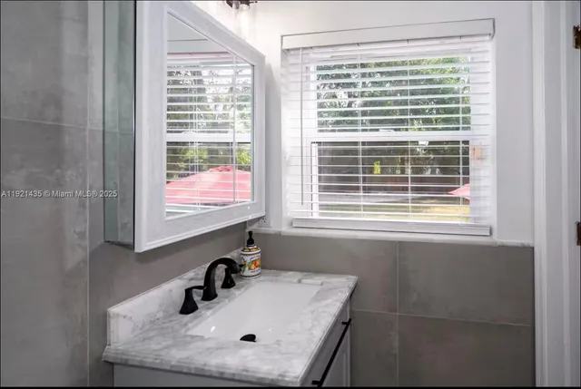 a bathroom with a sink and a window