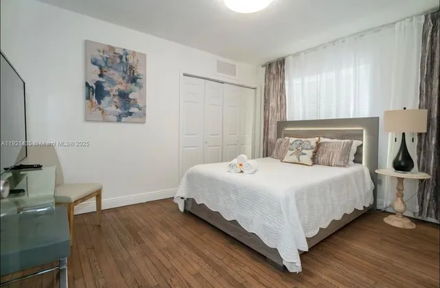 a bedroom with a bed and a desk