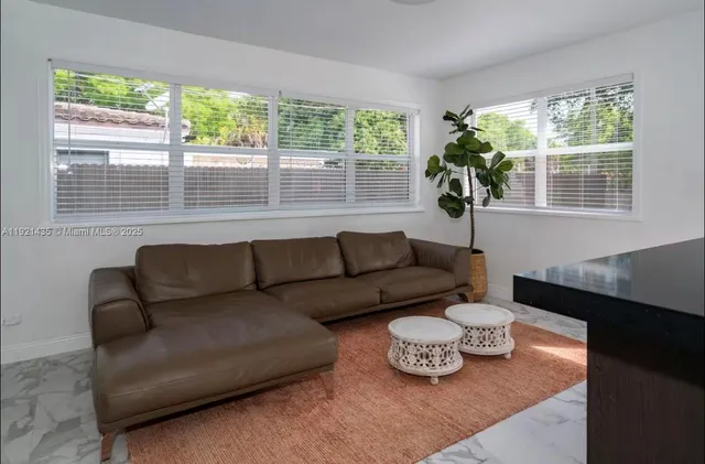 a living room with furniture and a window