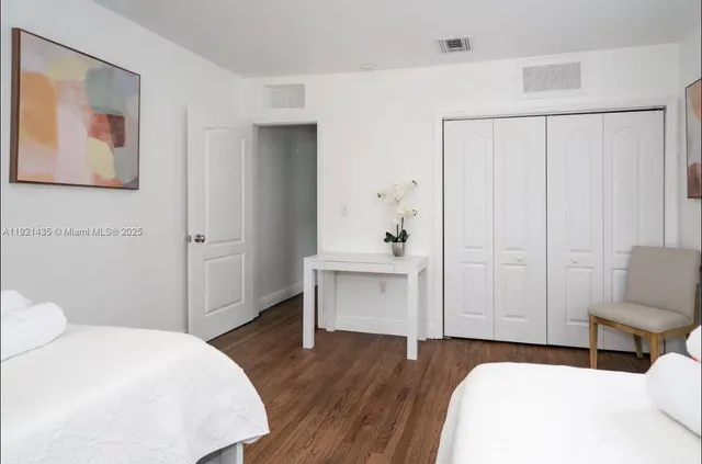 a bedroom with a bed and a chair