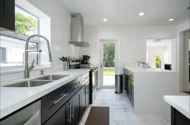 a kitchen with a sink stove and cabinets