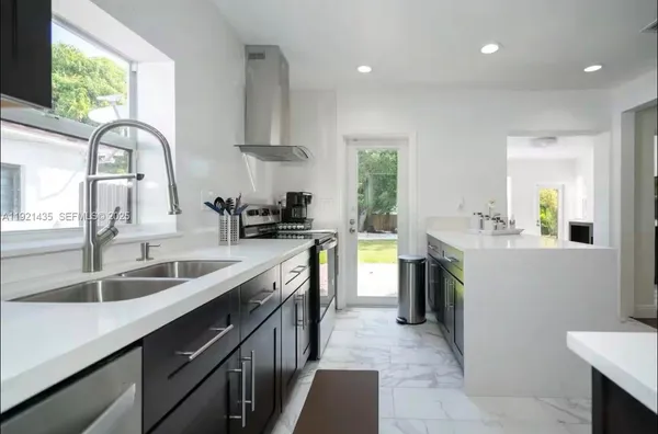 a kitchen with a sink stove and cabinets