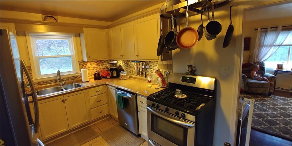Updated kitchen cabinets, floor, counter, and backsplash