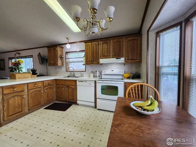 a kitchen with a sink appliances and cabinets