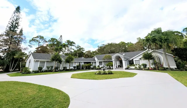 a view of house with yard and entertaining space