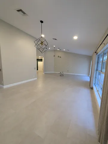 an empty room with closet and a ceiling fan