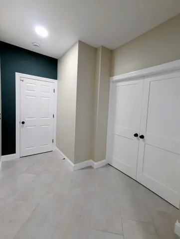 a bathroom with a toilet a sink a mirror and vanity