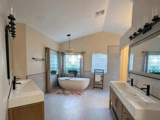 a front view of a house with a yard and potted plants