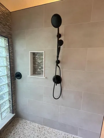 a kitchen with stainless steel appliances granite countertop wooden cabinets a refrigerator a sink a stove a microwave and wooden floors