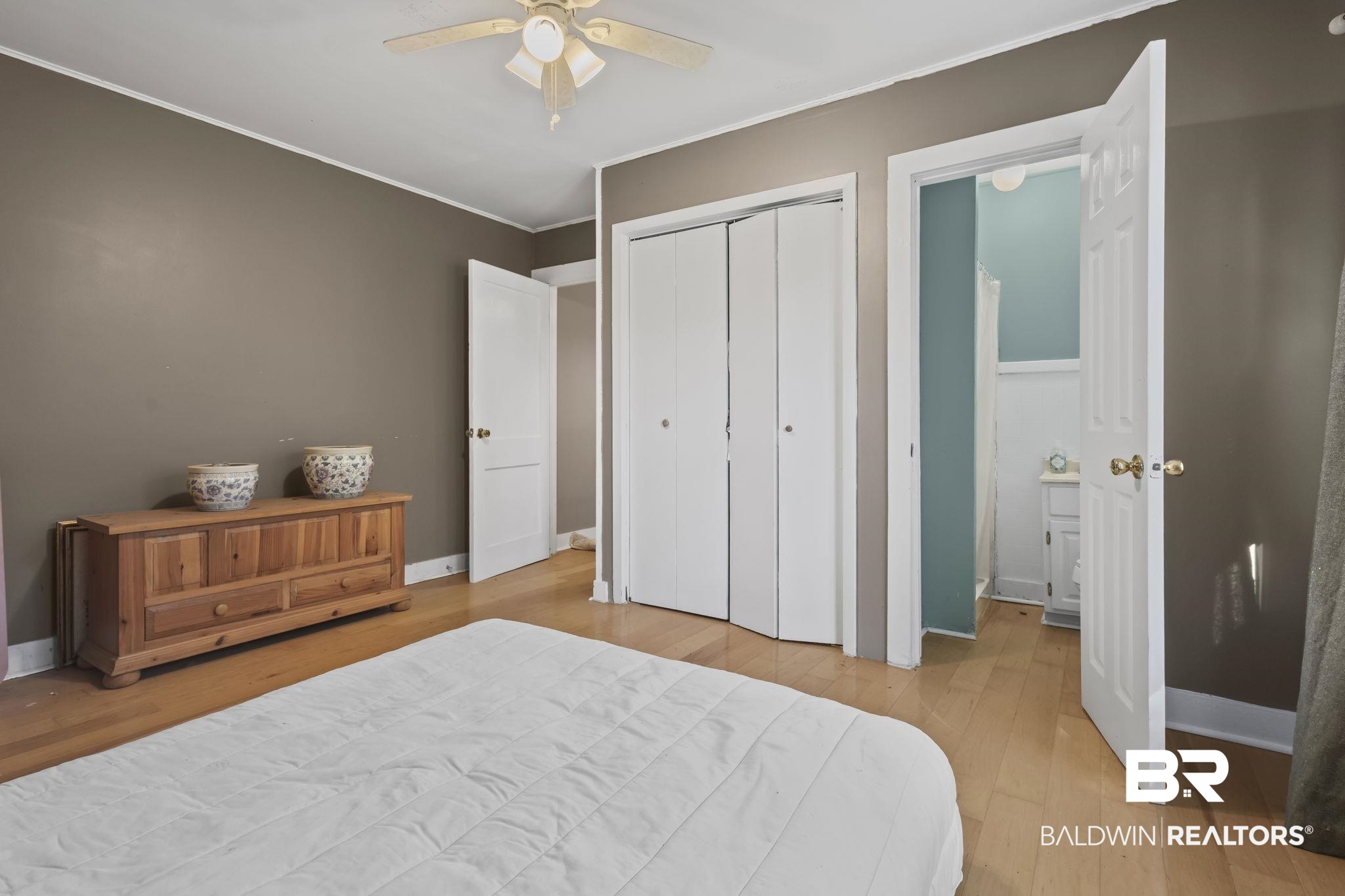 18696 Borck Road Gulf Shores, AL 36542 - Photo 11 of 47 Bedroom with ceiling fan, a closet, light hardwood / wood-style floors, and ornamental molding