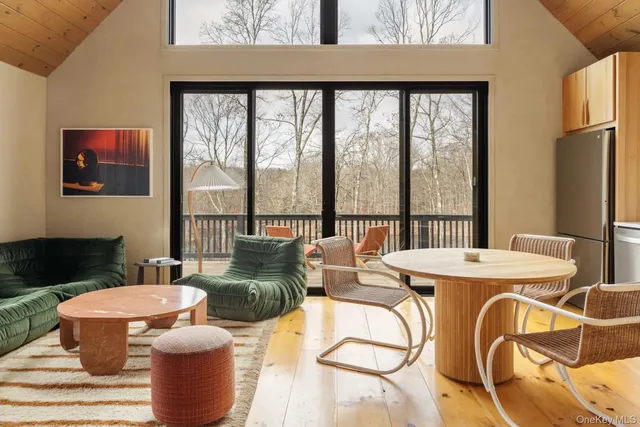 a living room with fireplace furniture and a floor to ceiling window