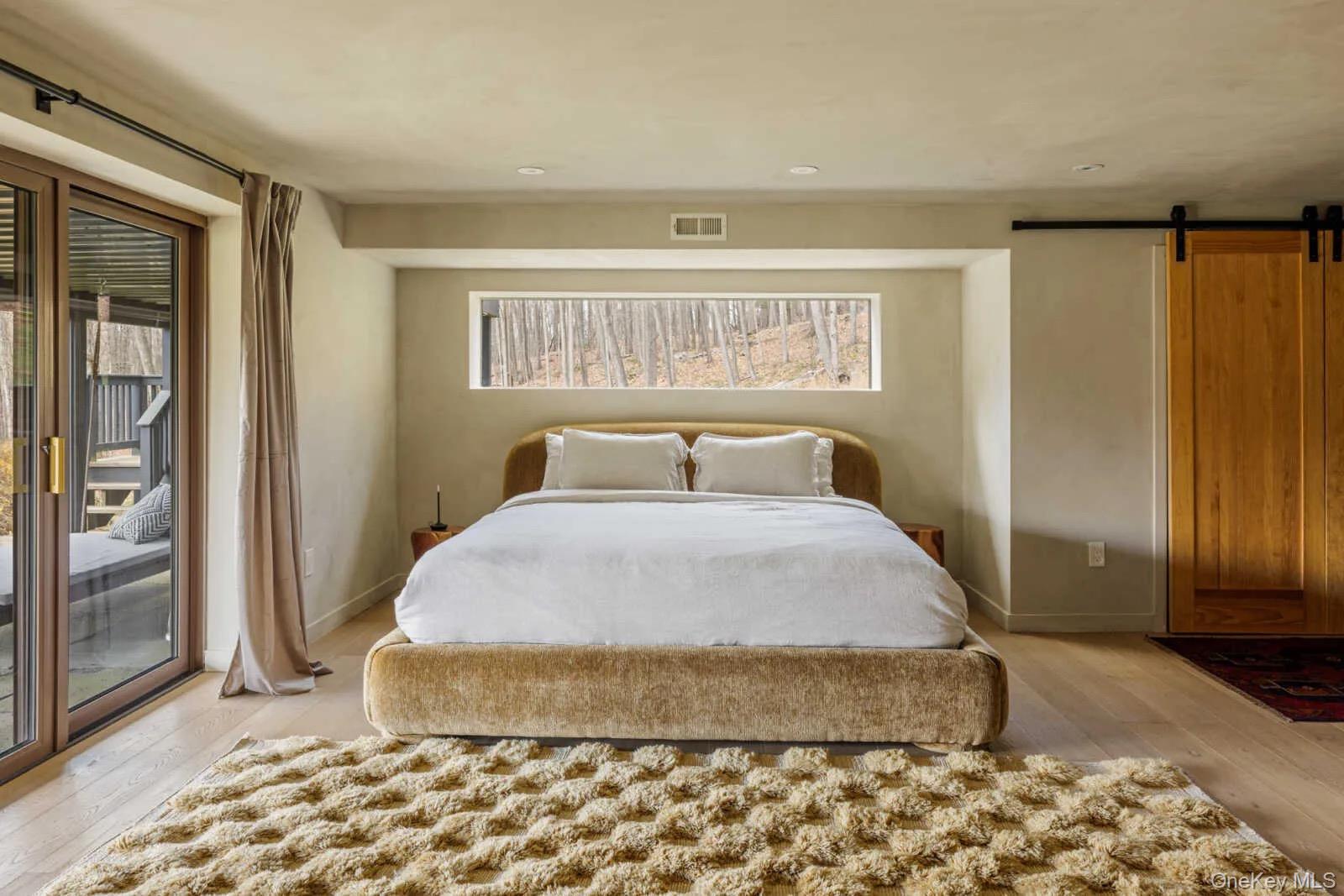 407 White Schoolhouse Road Rhinebeck, NY 12572 - Photo 6 of 17 a bedroom with a bed and wooden floor