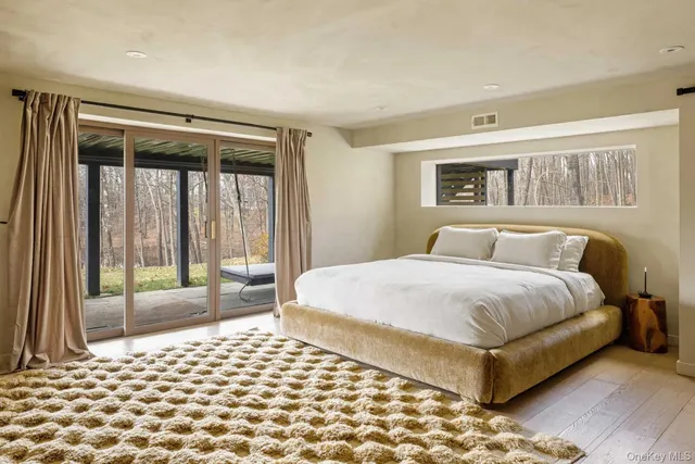 a bedroom with a large bed and a tv