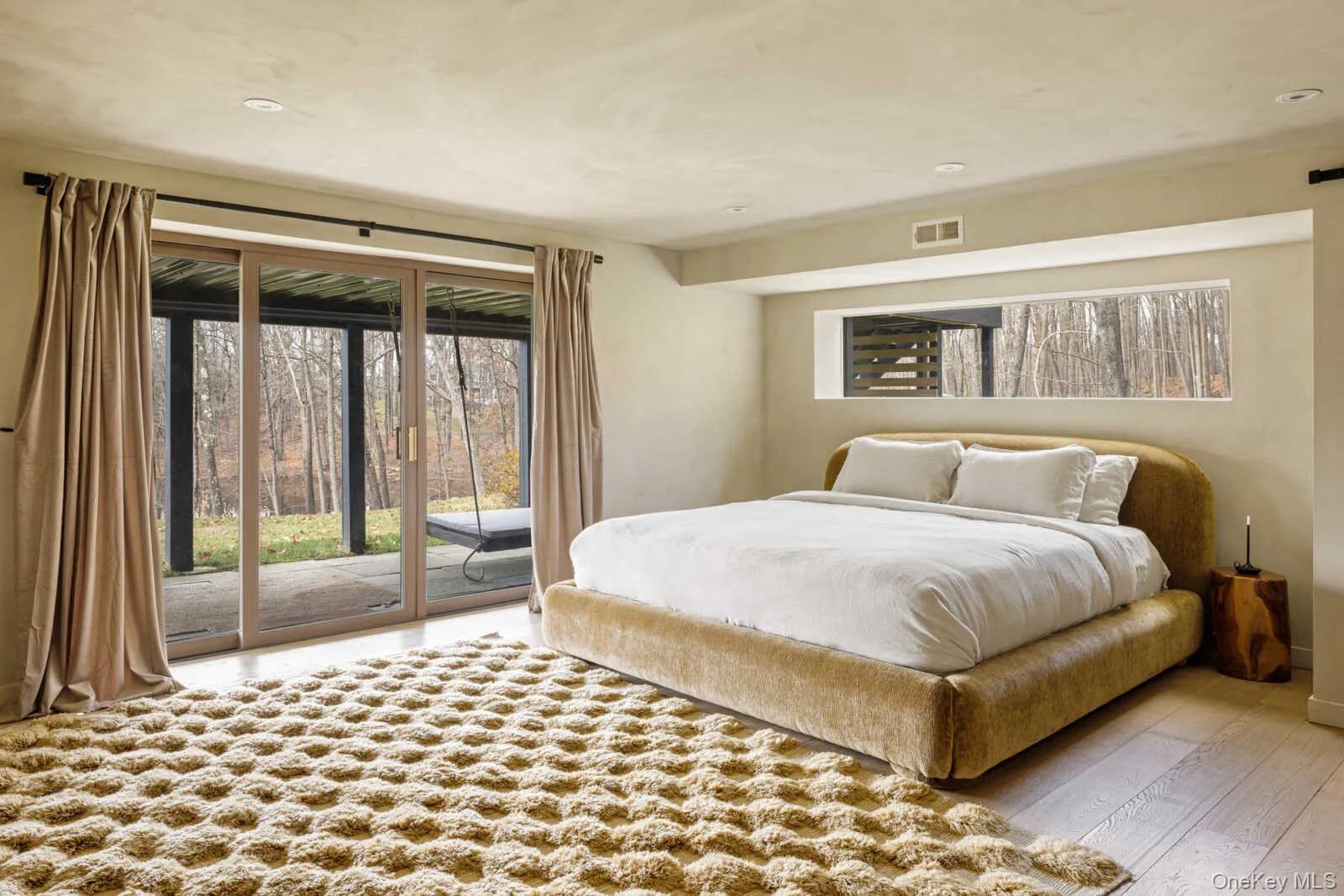 407 White Schoolhouse Road Rhinebeck, NY 12572 - Photo 7 of 17 a bedroom with a large bed and a tv