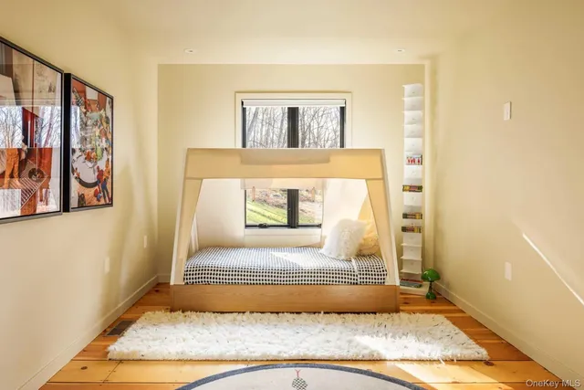 a bedroom with a bed and a window
