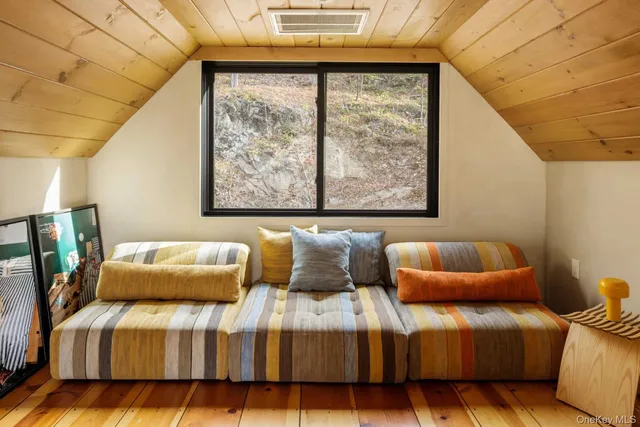 a blue couch sitting in front of a window