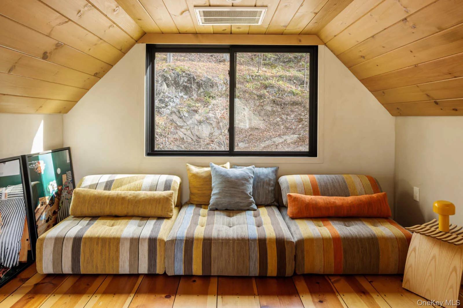 407 White Schoolhouse Road Rhinebeck, NY 12572 - Photo 10 of 17 a blue couch sitting in front of a window