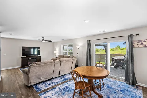 a kitchen with granite countertop white cabinets stainless steel appliances and a window
