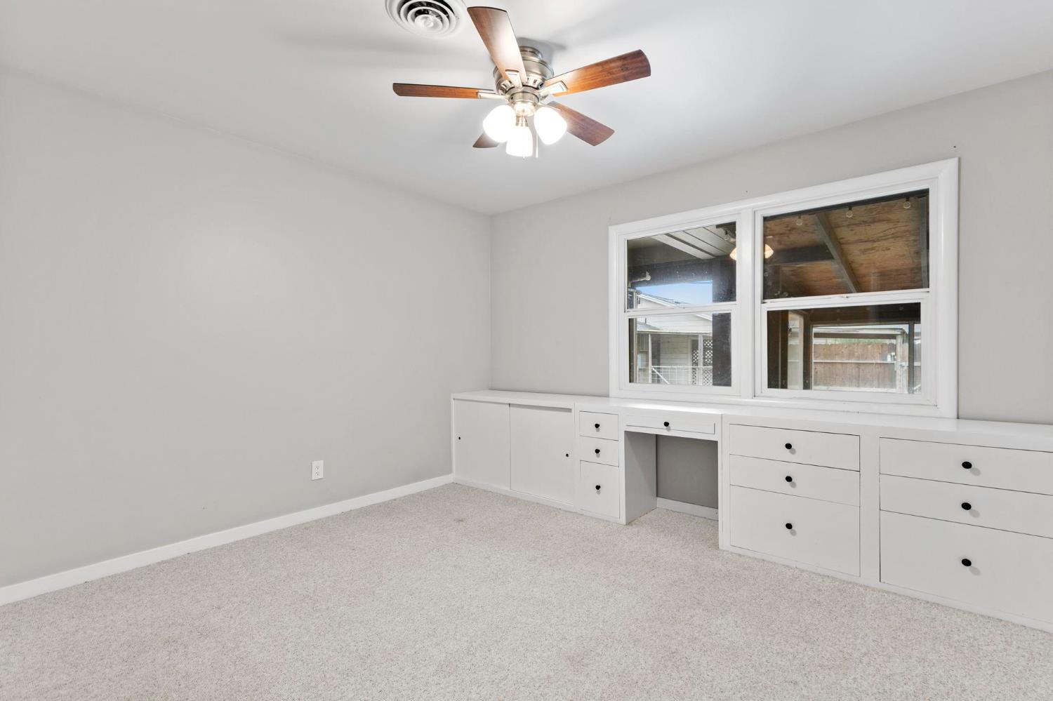 731 Sioc Street Colusa, CA 95932 - Photo 17 of 30 a room with a chandelier fan and a window
