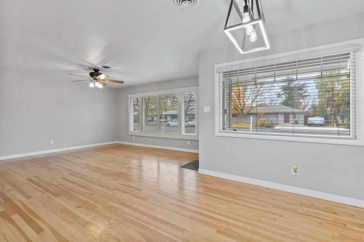 731 Sioc Street Colusa, CA 95932 - Photo 4 of 30 a view of an empty room with a window and wooden floor