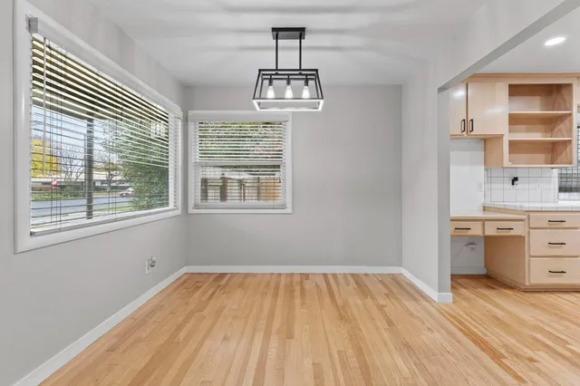 a view of white cabinets and a wooden floor