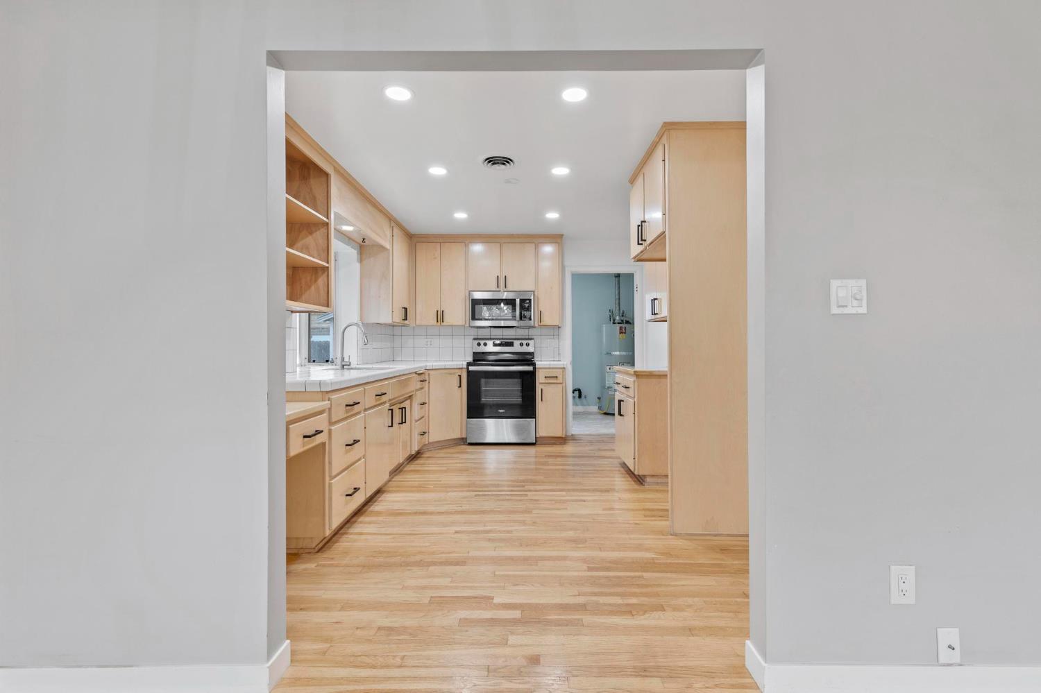 731 Sioc Street Colusa, CA 95932 - Photo 6 of 30 a large kitchen with cabinets and stainless steel appliances