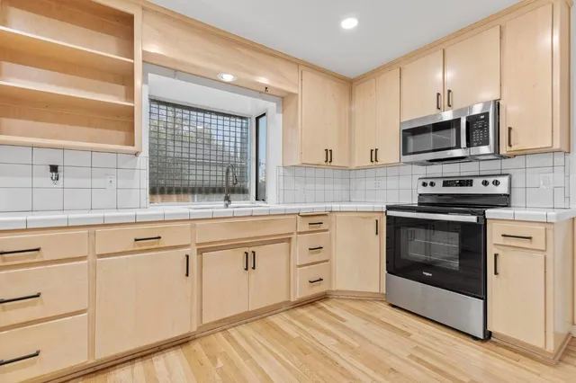 a view of hallway with wooden floor