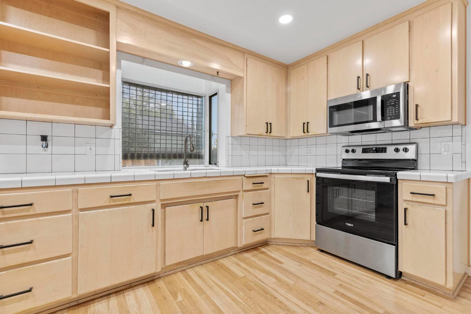 731 Sioc Street Colusa, CA 95932 - Photo 7 of 30 a kitchen with stainless steel appliances granite countertop a stove a sink and a microwave