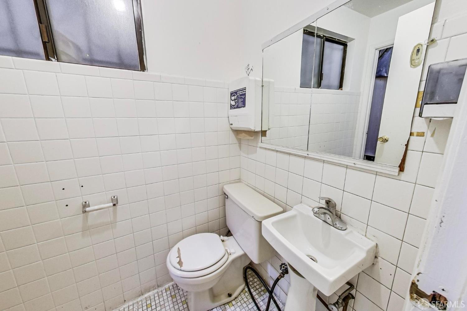 2811-2815 Telegraph Avenue Berkeley, CA 94705 - Photo 16 of 73 a bathroom with a sink toilet and mirror