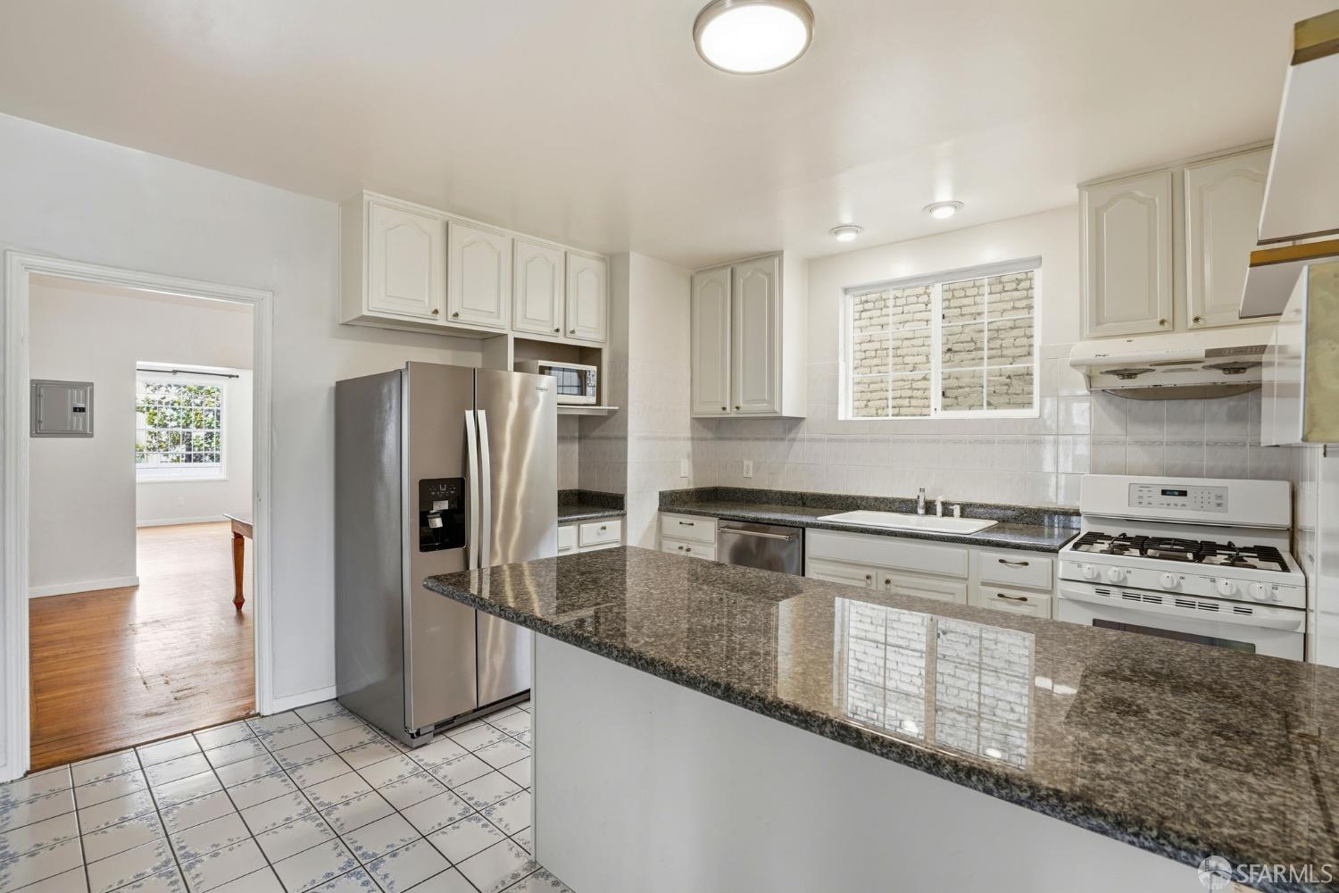 2811-2815 Telegraph Avenue Berkeley, CA 94705 - Photo 24 of 73 a kitchen with stainless steel appliances granite countertop a stove a sink and a refrigerator
