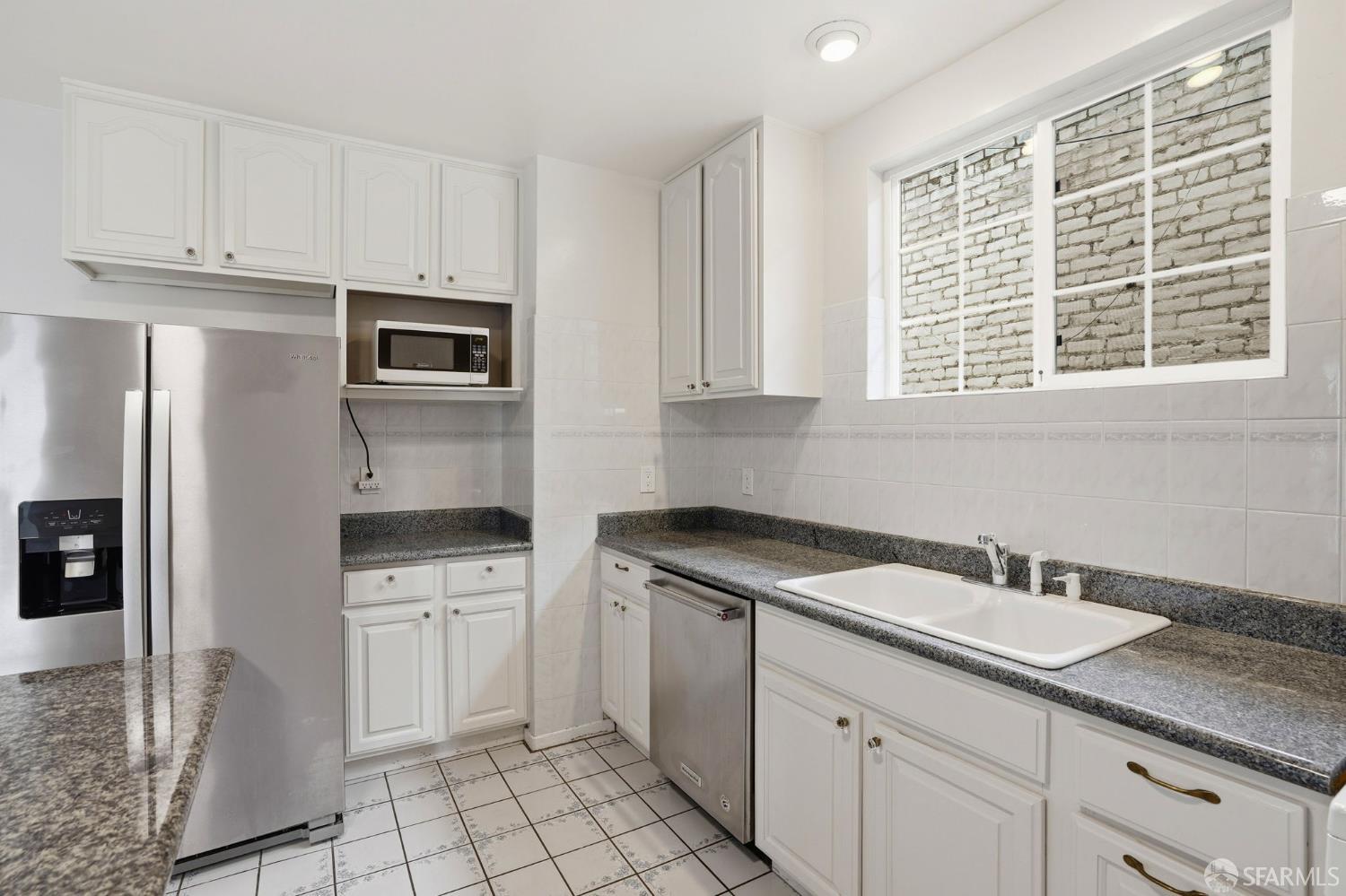 2811-2815 Telegraph Avenue Berkeley, CA 94705 - Photo 26 of 73 a kitchen with appliances cabinets and a sink