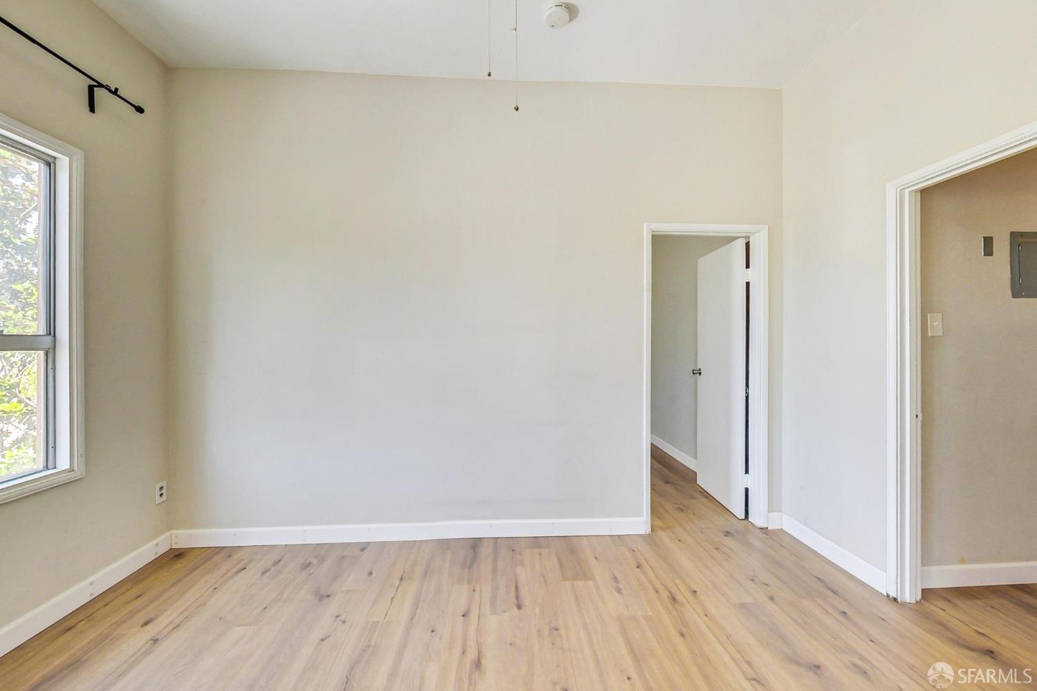 2811-2815 Telegraph Avenue Berkeley, CA 94705 - Photo 40 of 73 a view of an empty room with wooden floor and a window