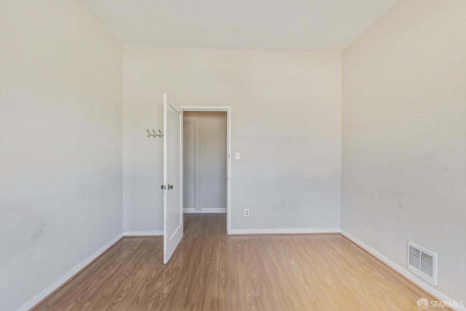2811-2815 Telegraph Avenue Berkeley, CA 94705 - Photo 46 of 73 a view of an empty room with wooden floor and a window