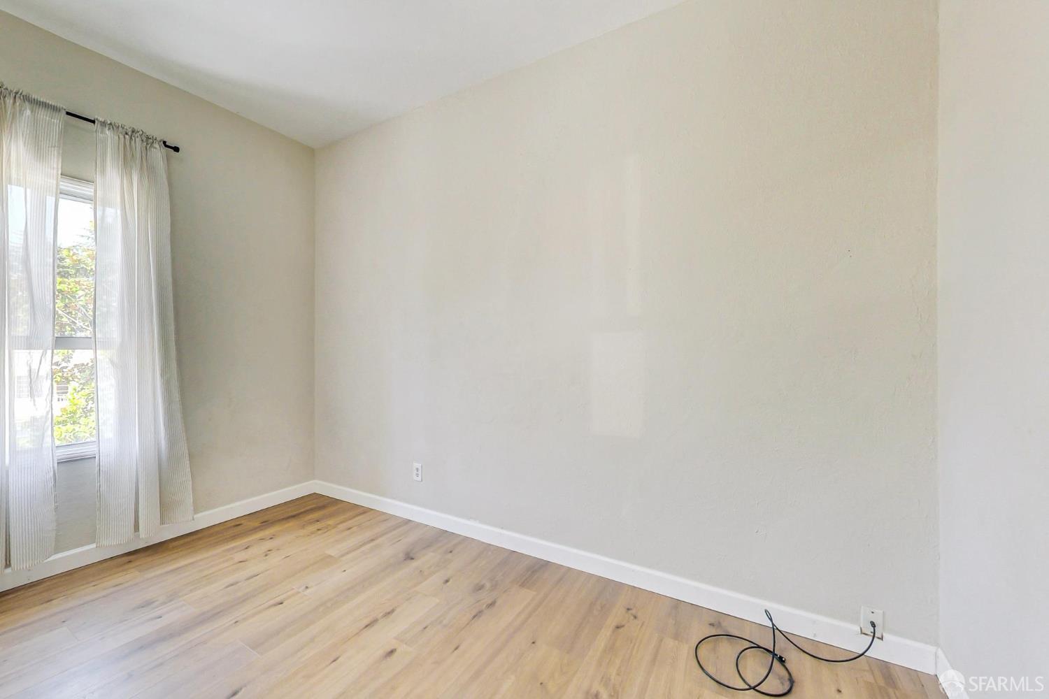 2811-2815 Telegraph Avenue Berkeley, CA 94705 - Photo 47 of 73 an empty room with wooden floor and windows