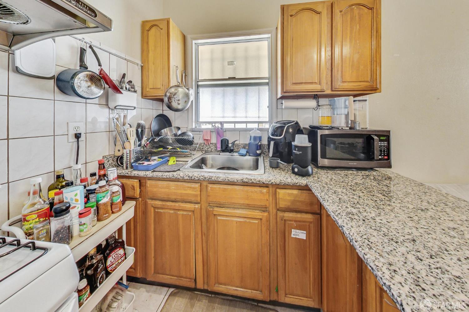 2811-2815 Telegraph Avenue Berkeley, CA 94705 - Photo 57 of 73 a kitchen with cabinets and window