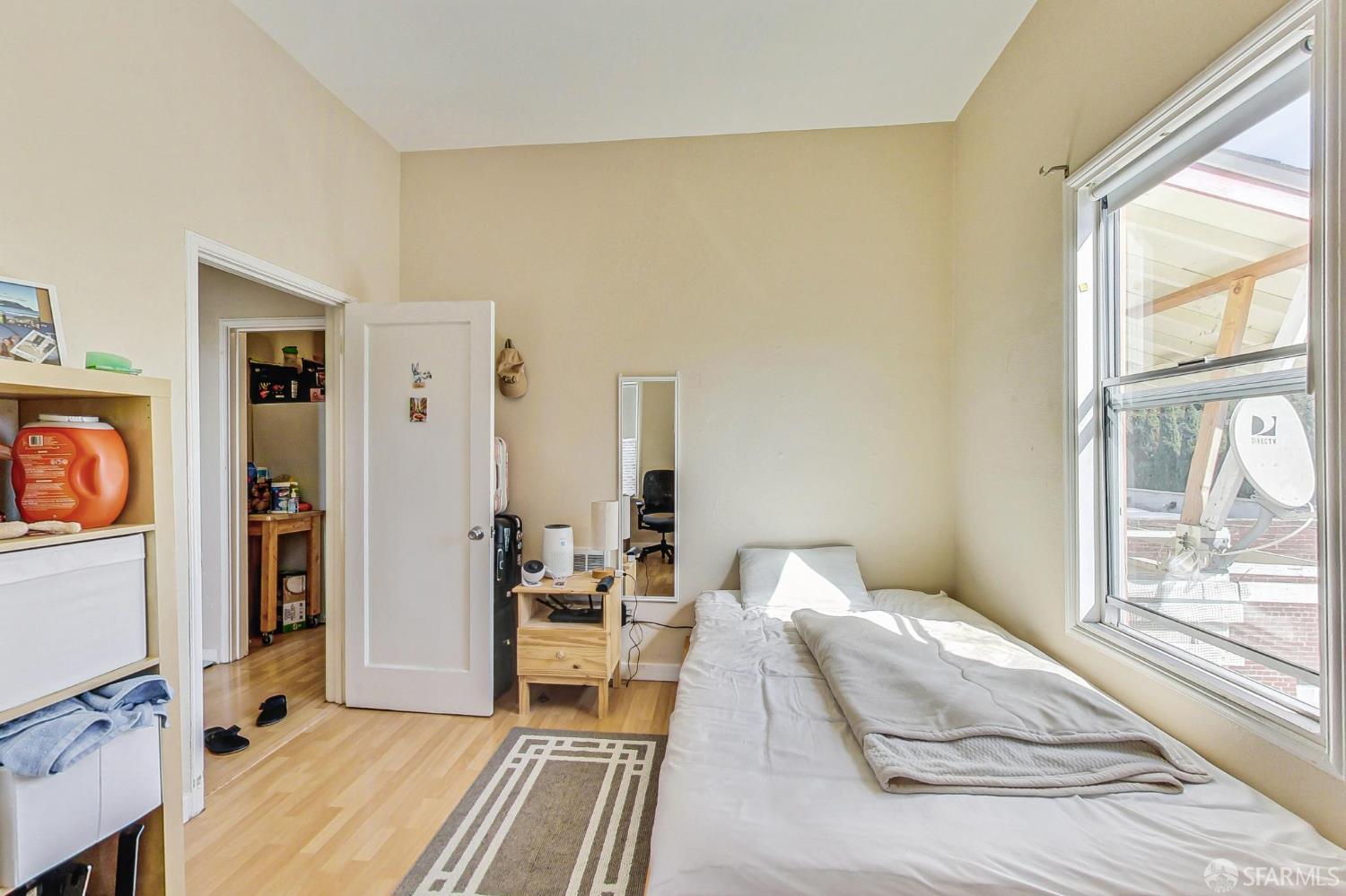 2811-2815 Telegraph Avenue Berkeley, CA 94705 - Photo 63 of 73 a bedroom with a bed and a flat tv screen next to a window