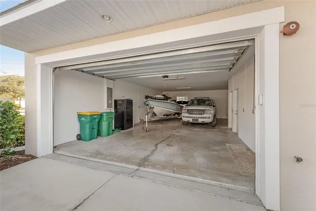 a living room with furniture kitchen view and a large window