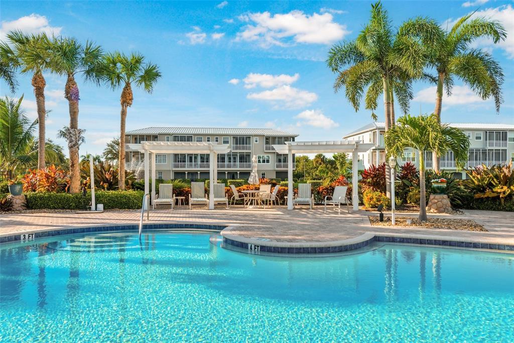 10311 Lands End Circle, Unit 16 Placida, FL 33946 - Photo 59 of 76 a view of a swimming pool with palm trees
