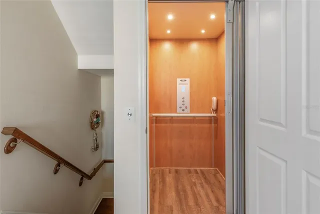a living room with furniture a chandelier and a window
